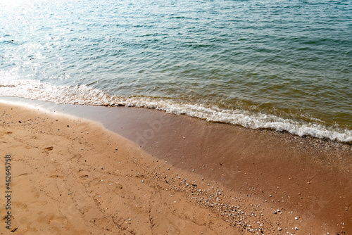 Nature in twilight period which including of sunrise over the sea and the nice beach. Summer beach with blue water and purple sky at the sunset.	
