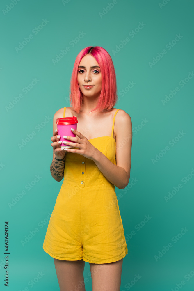 young woman with pink dyed hair holding paper cup with coffee to go isolated on blue young woman with pink dyed hair holding paper cup with coffee to go isolated on blue