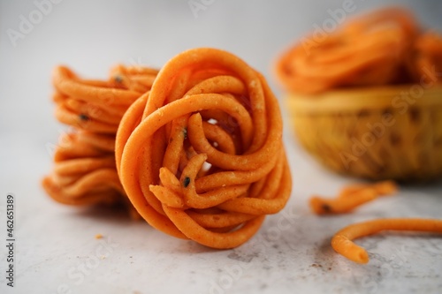 Homemade Murukku Chakli or Thenkuzhal - Navratri Diwali snacks isolated, selective focus photo