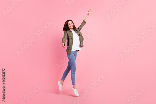 Full size photo of active short hairdo lady dance wear khaki shirt jeans sneakers isolated on pink color background