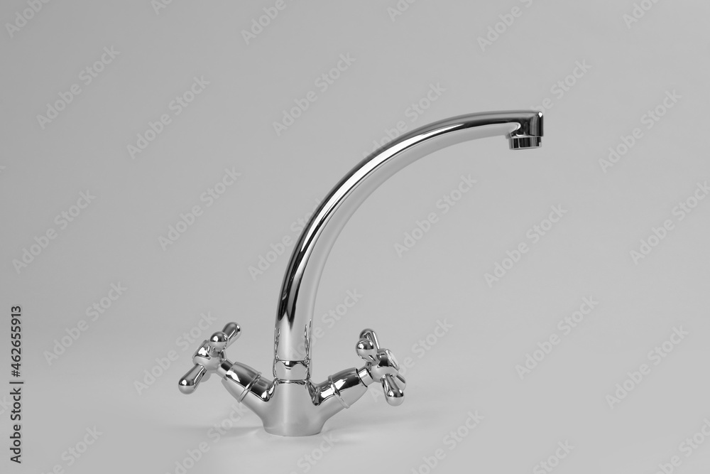 Double handle water tap on grey background Double handle water tap on grey background