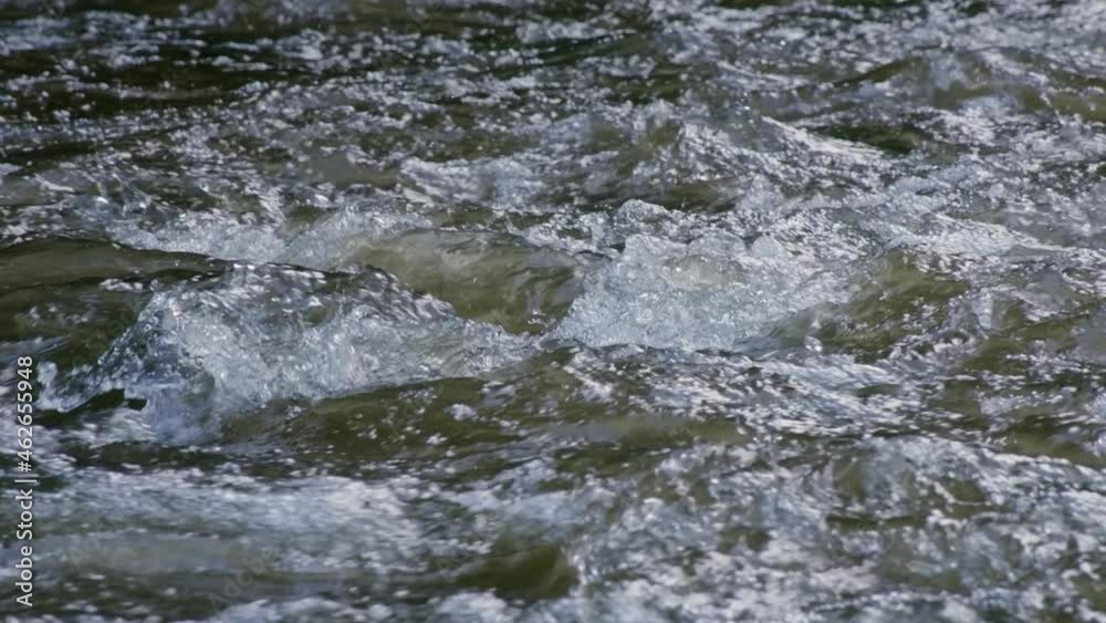 Wild river flowing, water splashing in slow motion Wild river flowing, water splashing in slow motion