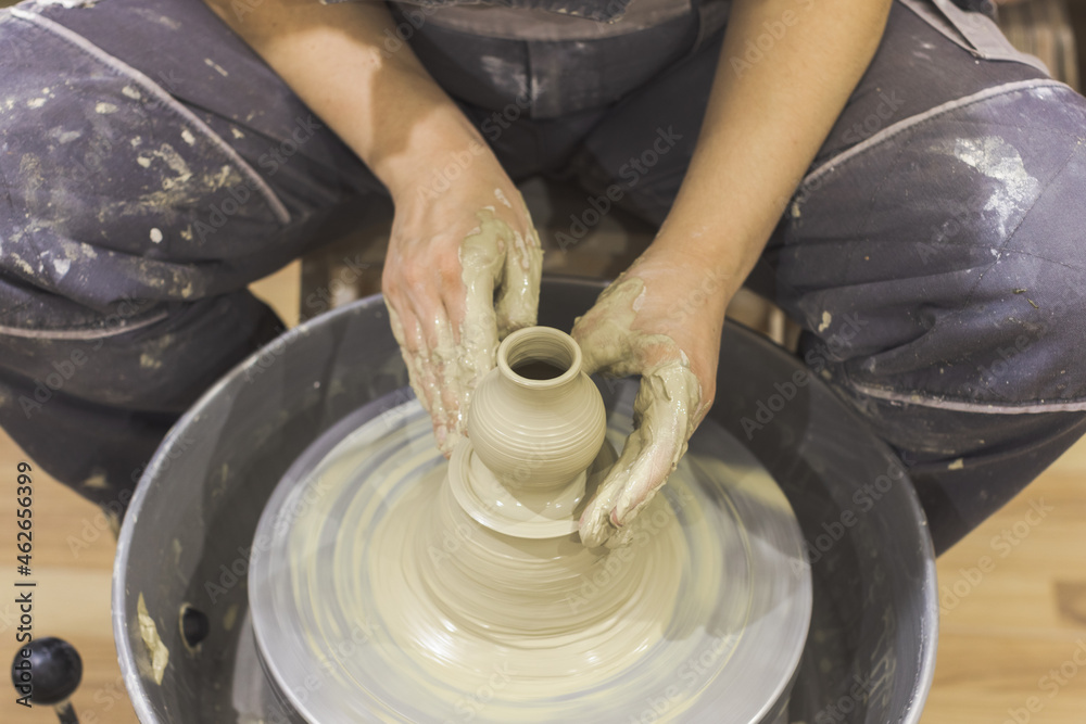 Ceramic Artist hands mold clay on pottery wheel. Arts creative workshop. Ceramic Artist hands mold clay on pottery wheel. Arts creative workshop.