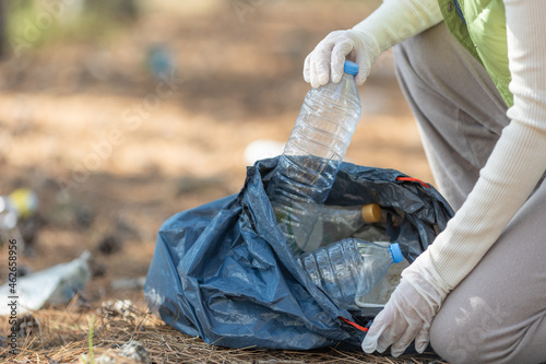 A woman removes rubbish in nature. High quality photo photo