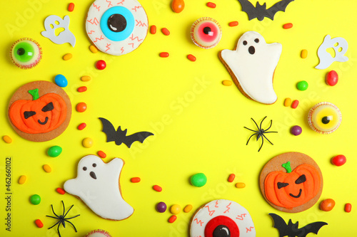 Halloween sweets on colored background close up top view with place for text
