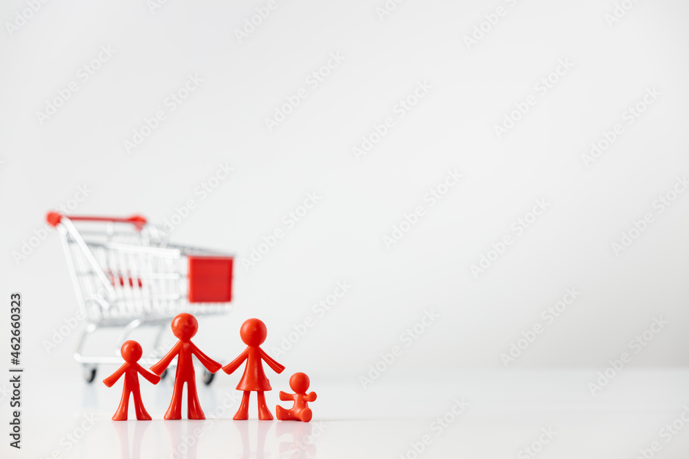 Miniature plastic figures family with children and Metallic shopping cart trolley on light gray background