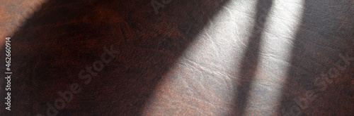 close-up of brown leather surface background with shadows