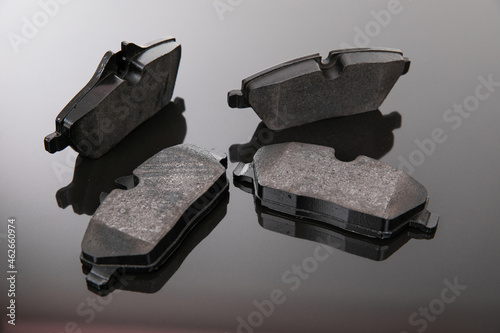 image photograph of brake pads on a black and gray background photo