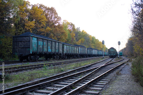 Railway tracks.Trains and wagons standing on the railway tracks against the background of autumn nature.