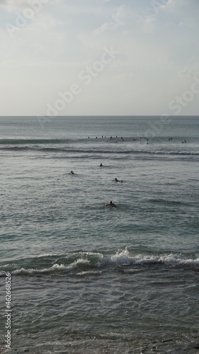 surfers entering the sea perfect wave sunset ocean extreme sport surfers horizon landscape Indonesia Bali waves water sand composition