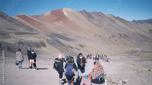 Vinicunca or Winikunka, a mountain in the Andes of Peru, Rainbow mountain. Tourists looking around. photo