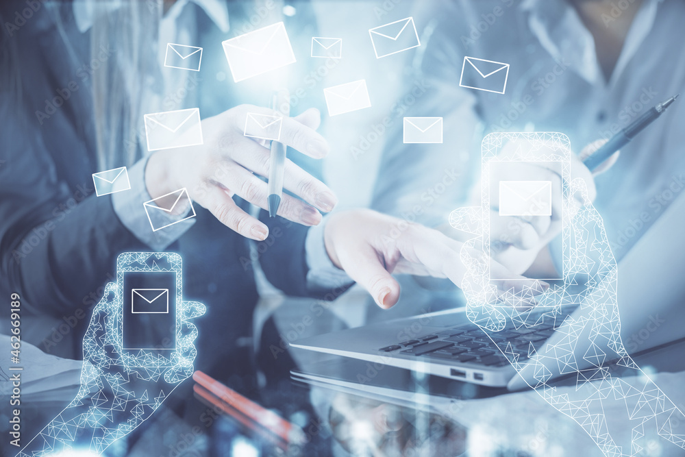 Double exposure of man and woman working together and envelop hologram drawing. e-mail concept. Computer background. Double exposure of man and woman working together and envelop hologram drawing. e-mail concept. Computer background.