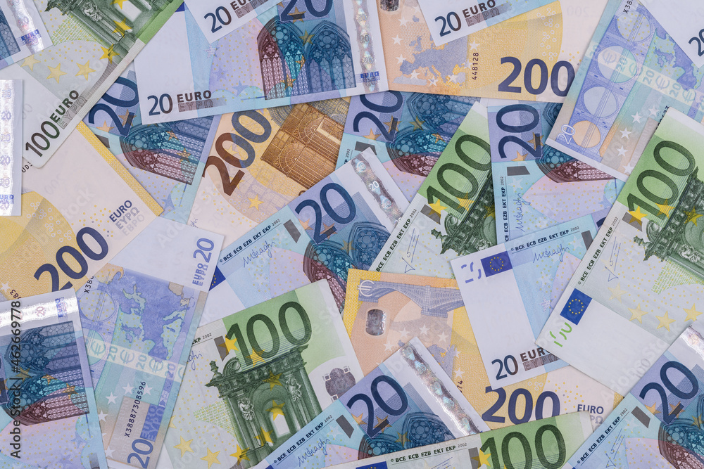 Banknotes in denominations of 20 and 200 euros against the background of other European banknotes of various denominations Banknotes in denominations of 20 and 200 euros against the background of other European banknotes of various denominations