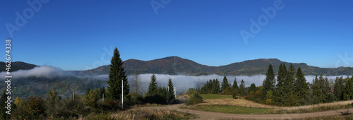 Panoramic view of misty Carpathian mountains forests early morning