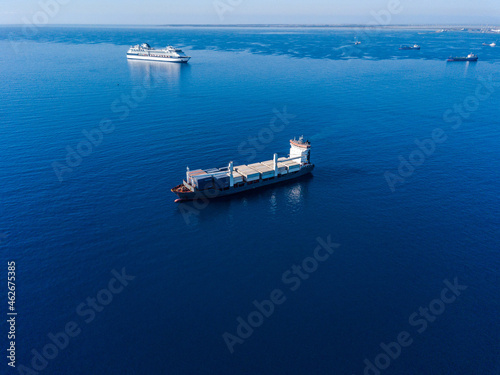 Aerial view on container ship shipping cargo. Export, import and logistic