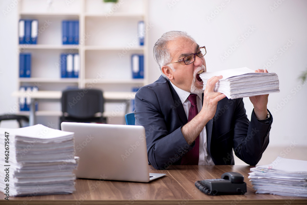Old male employee and too much work in the office Old male employee and too much work in the office