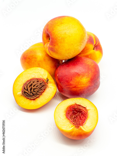 sliced and whole nectarines heap on white background