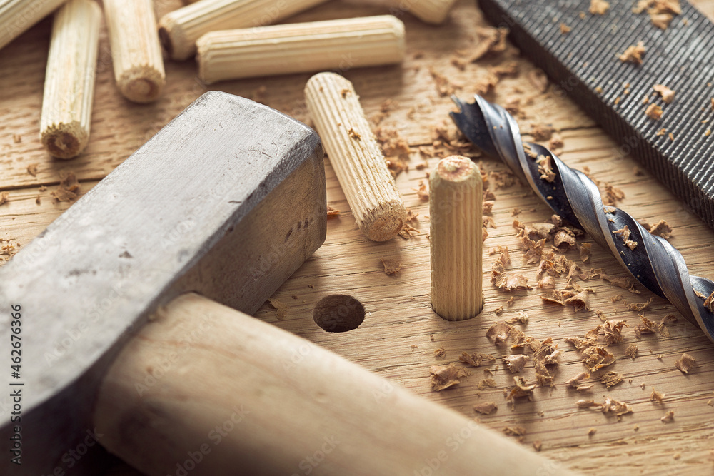 drill bit, hammer, dowel and rasp on wooden oak board drill bit, hammer, dowel and rasp on wooden oak board