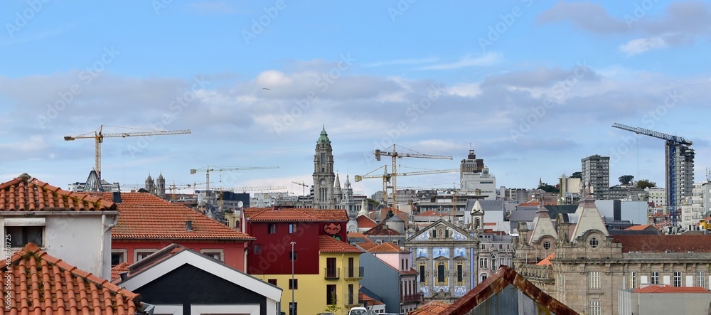 City landscape. Lots of construction cranes over the roofs of different of houses