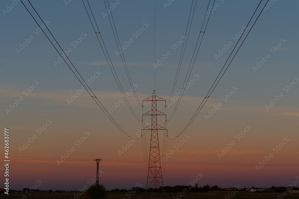 High voltage pole at sunset. Electricity grid