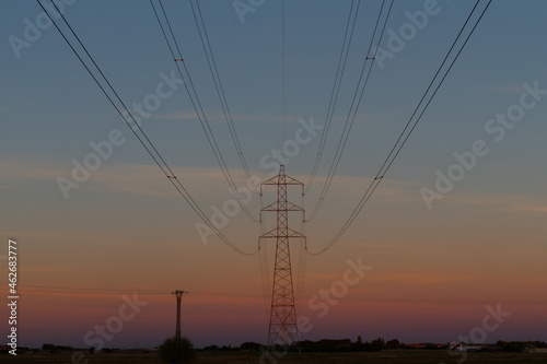 High voltage pole at sunset. Electricity grid
