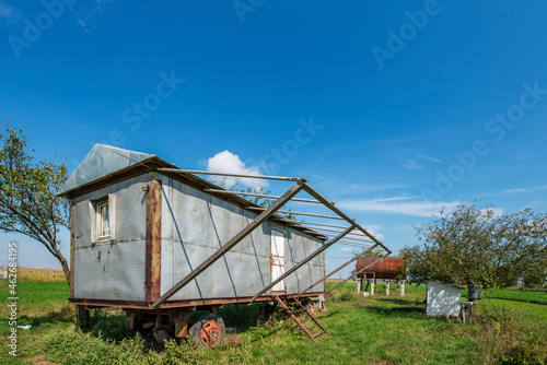 vintage mobile prefabricated house installed in a field with water tank © Toyakisfoto.photos