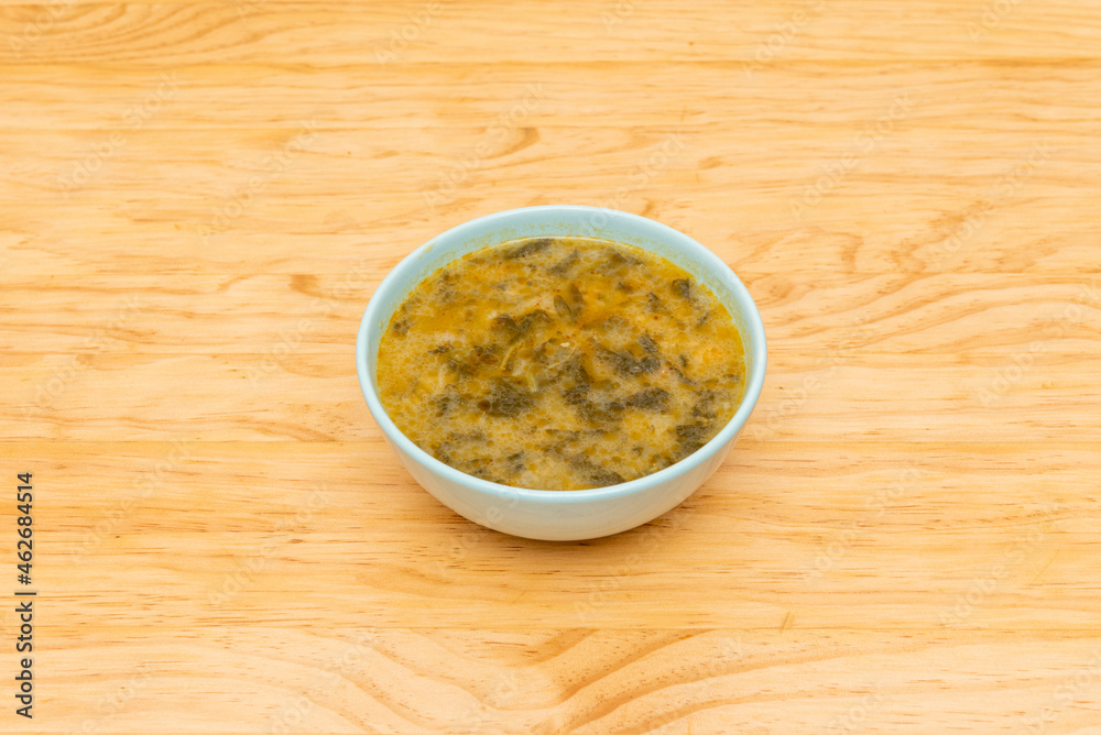 bowl with cooked chickpeas with spinach on light wooden table bowl with cooked chickpeas with spinach on light wooden table