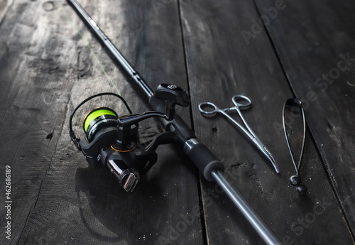 Reel of fishing rod, scissors, extractor close up. Fishermans equipment.