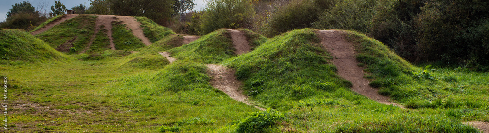 A bike park with small trails, jumps and hills A bike park with small trails, jumps and hills