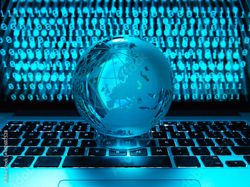 Globe illustrating the world on a laptop computer with screen been infected by a cyber attack photo