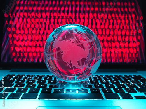 Globe illustrating the Americas on a laptop computer with screen been infected by a cyber attack