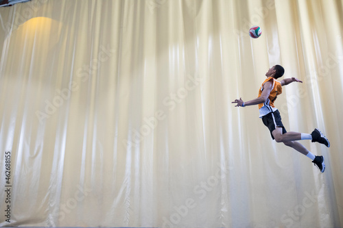 Man jumping during a volleyball match to start a game photo