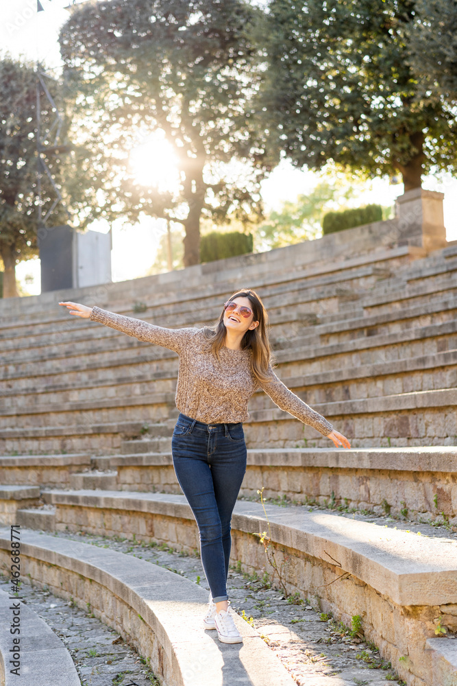 Happy young woman balancing on stairs outdoors Happy young woman balancing on stairs outdoors