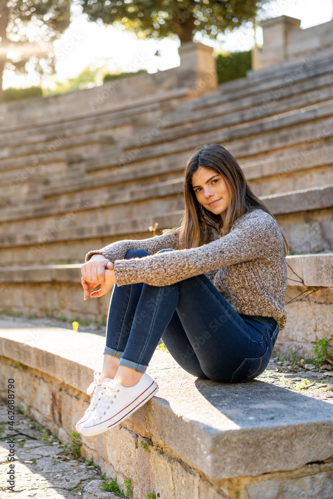 Portrait of young woman sitting on stairs outdoors Portrait of young woman sitting on stairs outdoors