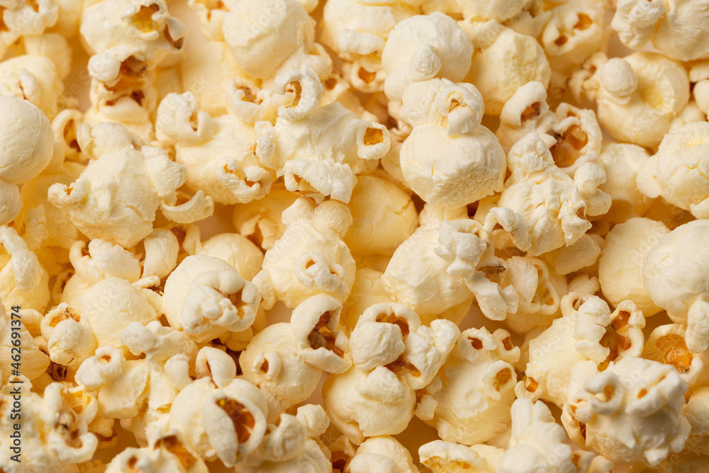 A lots of salted popcorn as a textured background for food advertising