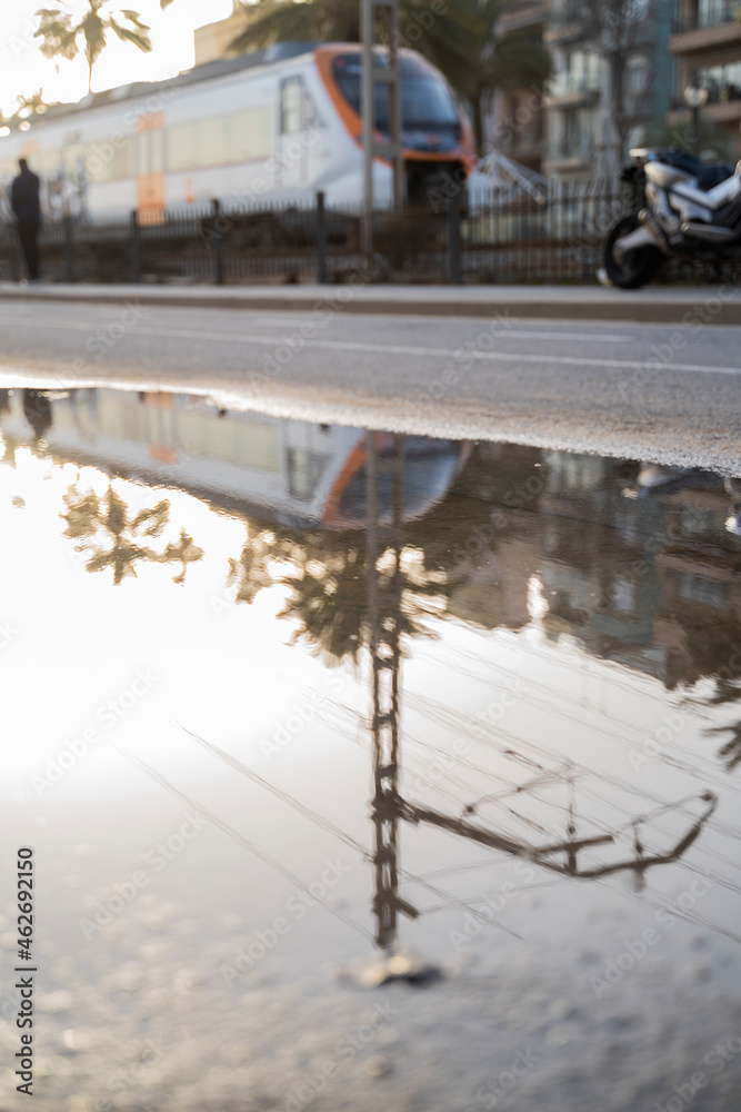 Spain, Barcelona, Badalona, Subway train reflecting in puddle of water Spain, Barcelona, Badalona, Subway train reflecting in puddle of water