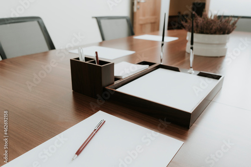 Ballpen and paper on conference table in office photo