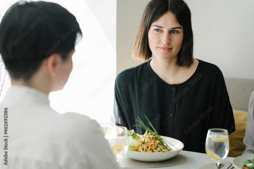 Friends having salad and mineral water in a restaurant Friends having salad and mineral water in a restaurant