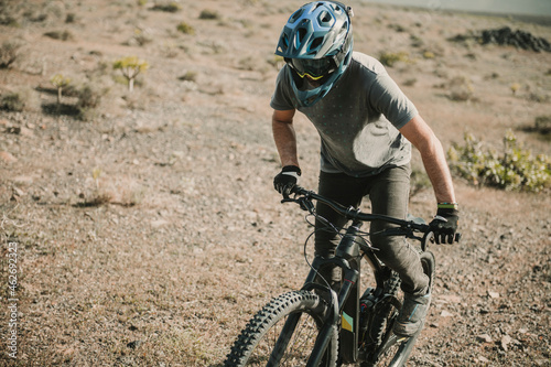 Spain, Lanzarote, mountainbiker on a trip in desertic landscape photo