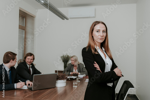 Portrait of confident young businesswoman on a meeting in conference room