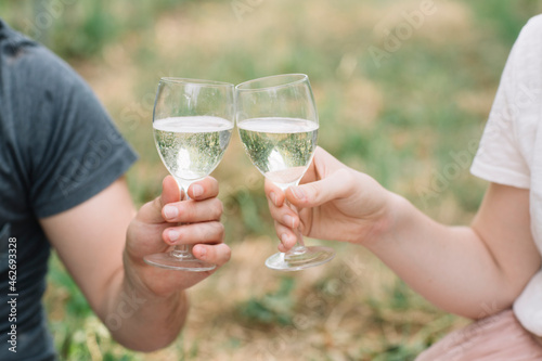 Young couple toasting with Prosecco in the vineyards, close-up