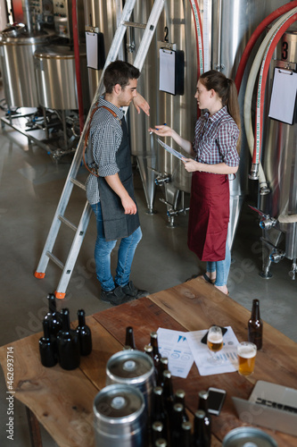 Young entrepreneurs working at a brewery photo