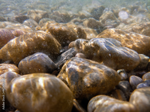 Fototapeta Naklejka Na Ścianę i Meble -  Pebbles stone underwater below water surface near lake shore, natural scene