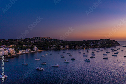 Spain, Mallorca, Santa Ponsa, Aerial view of boats floating in coastal water at dusk photo