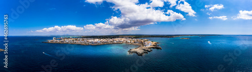 Spain, Balearic Islands, Colonia de Sant Jordi, Aerial panorama of Mediterranean Sea and town along shore of Cala Galiota bay in summer photo