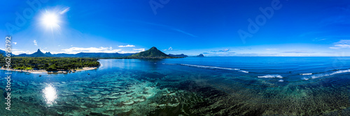 Mauritius, Black River, Flic-en-Flac, Aerial panorama of blue coastline of Indian Ocean with Tourelle du Tamarin mountain in distant background