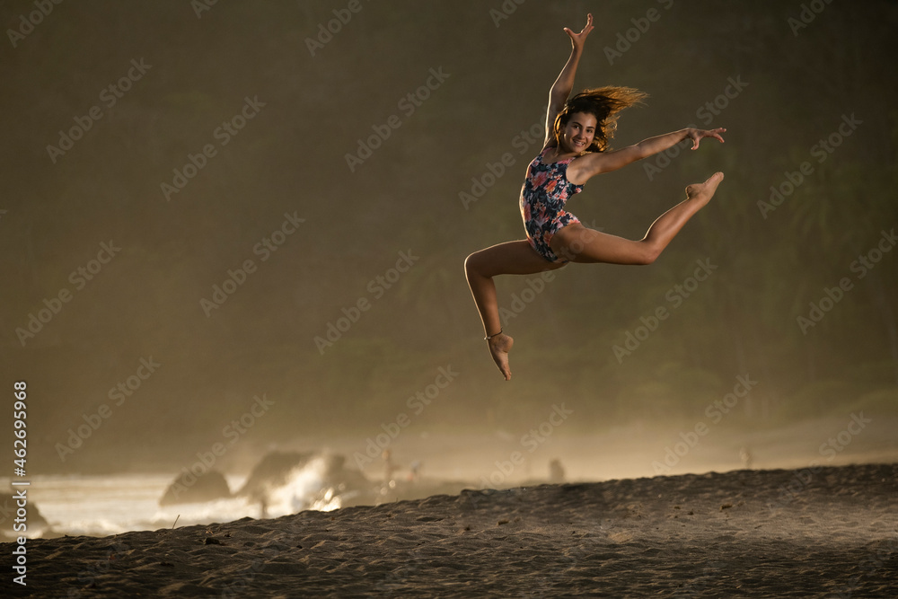 Portrait of happy teenage girl practicing gymnastic on the beach at twilight, Jaco Beach, Costa Rica Portrait of happy teenage girl practicing gymnastic on the beach at twilight, Jaco Beach, Costa Rica