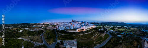 Italy, Province of Brindisi, Ostuni, Aerial panorama of hillside old town at dusk photo