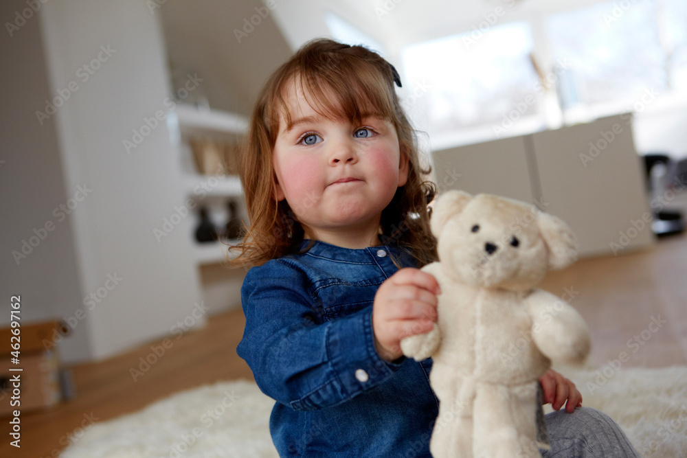 Portrait of toddler girl with teddy bear sitting on the floor at home Portrait of toddler girl with teddy bear sitting on the floor at home