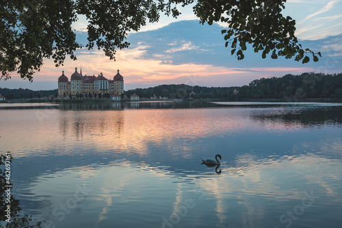 Germany, Saxony, Moritzburg Castle at castle pond in the evening photo